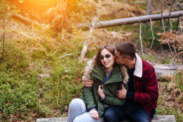 istock guy kisses his girlfriend in the forest 910311524