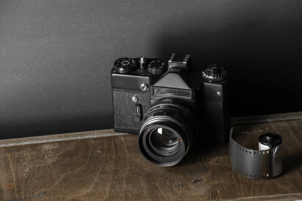 istock Old retro camera and 35 mm film 910314718