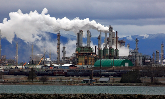 Smoke Billows from Oil Refinery Chimneys