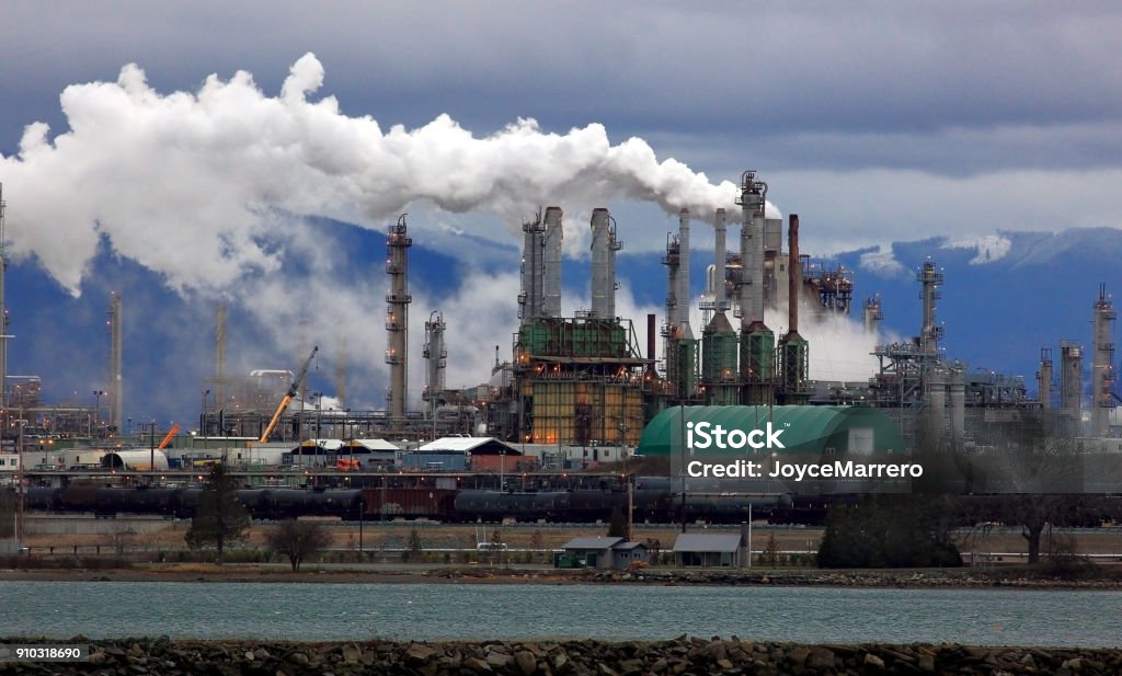 Smoke Billows from Oil Refinery Chimneys Pollution from oil refinery impacts wildlife habitats, air, and water quality and endanger the health of nearby communities. Oil Refinery Stock Photo