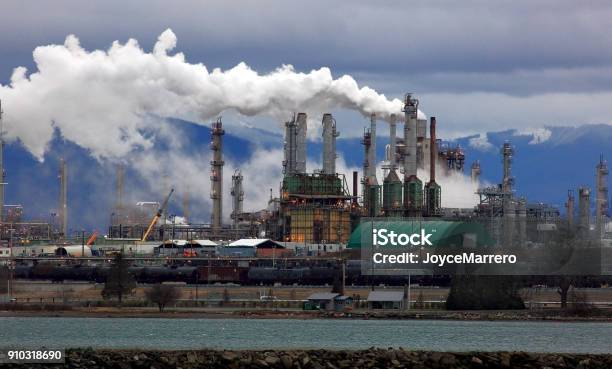 Smoke Billows From Oil Refinery Chimneys Stock Photo - Download Image Now - Oil Refinery, Pollution, Factory