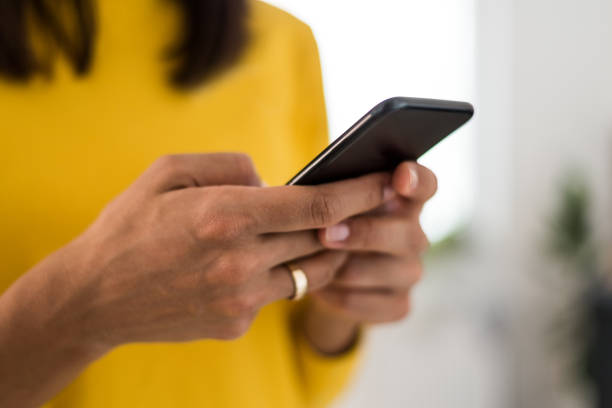istock Young woman typing on a smartphone at home office 910325734
