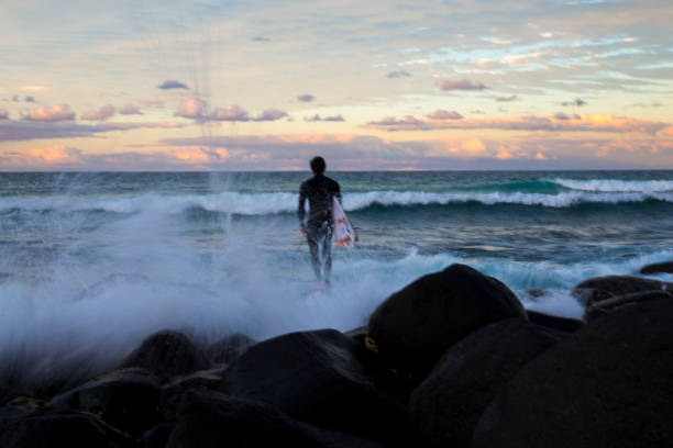 Gold Coast,QLD, Australia - August 09, 2016. A surfer is waiting for a wave at Burleigh Heads at the Gold Coast.