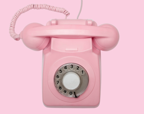 3D rendering pink vintage phone isolated on white background.