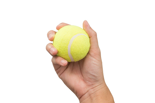 Hand holding tennis ball isolated on white background.