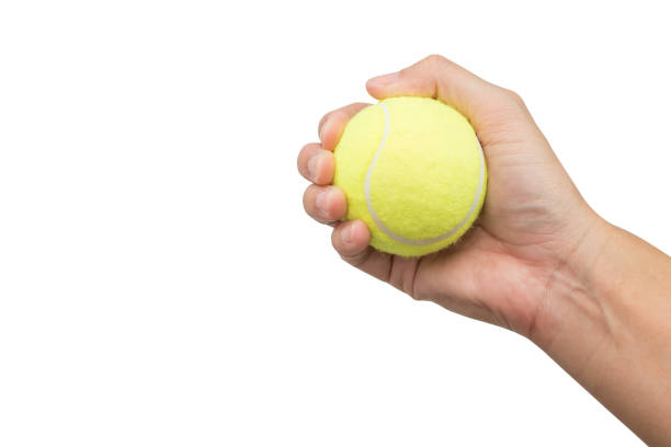 istock Holding tennis ball isolated on white background. 910339878