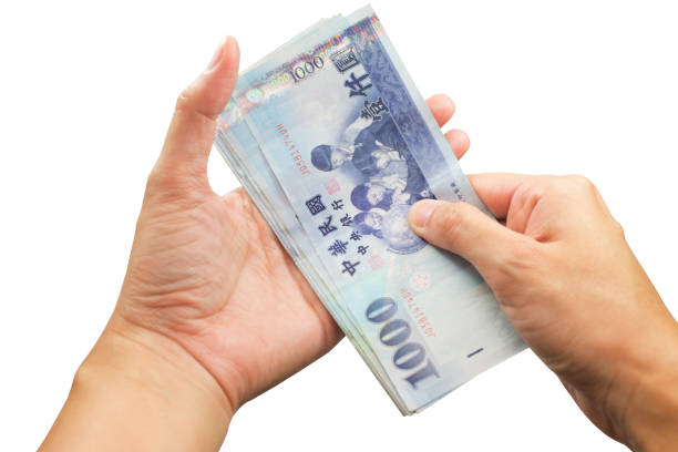 istock Hand giving a Taiwan money on isolate white background. 910340058