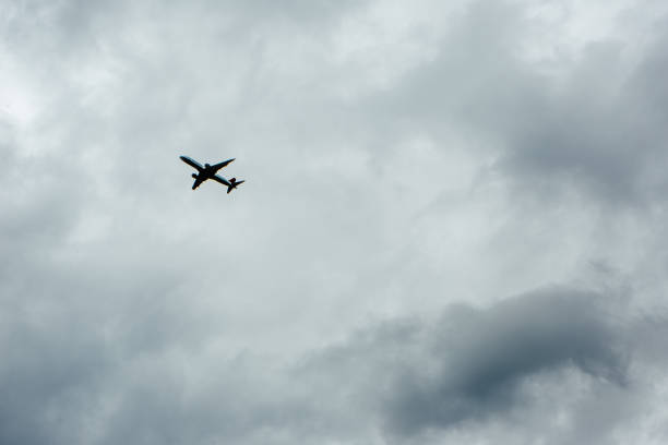 istock Air plane transportation. Silhouetted air plane against stormy sky 910345188