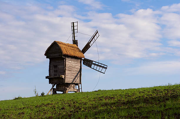 istock Windmill with straw roof on green meadow 91034976