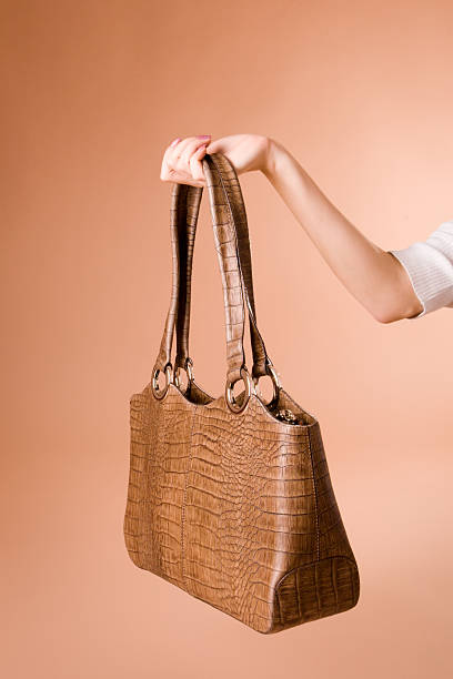 istock Hand holding handbag on the beige background 91035101