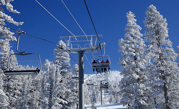 Riding a lift at ski resort. stock photo
