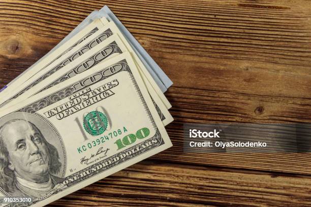Stack Of One Hundred Dollars Bills On Wooden Desk Stock Photo - Download Image Now - Table, Currency, Stack