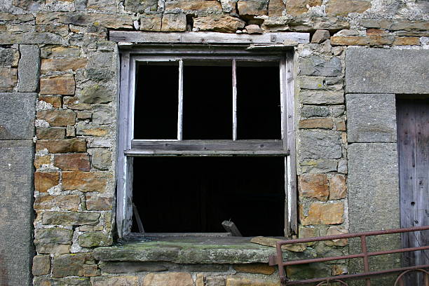istock broken windown in abandoned farm house 91035468