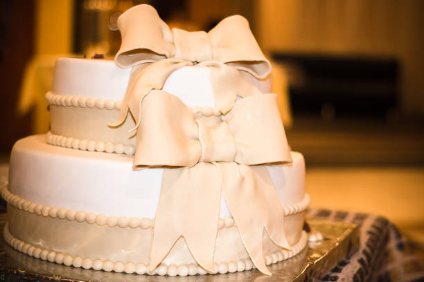 stylish white gold cake, decorated with ribbons and beads, the wedding Banquet