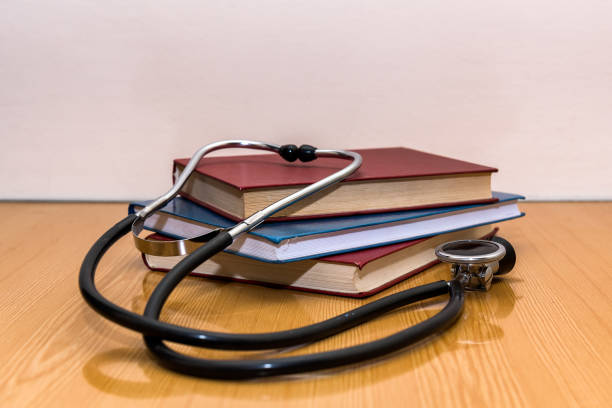 istock Stethoscope and medical books lying on a table 910357394