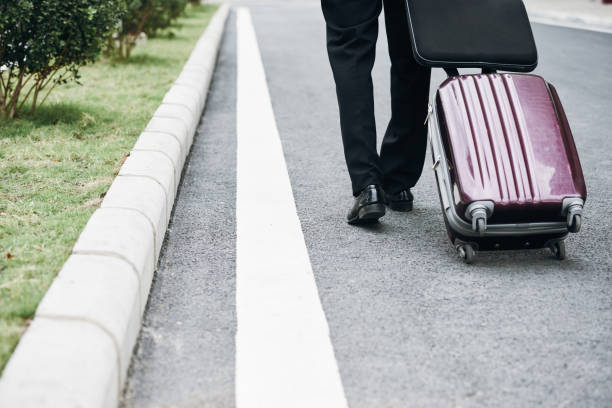 istock Businessman with luggage 910357544