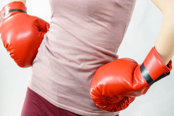 istock Woman wearing boxing gloves 910357604