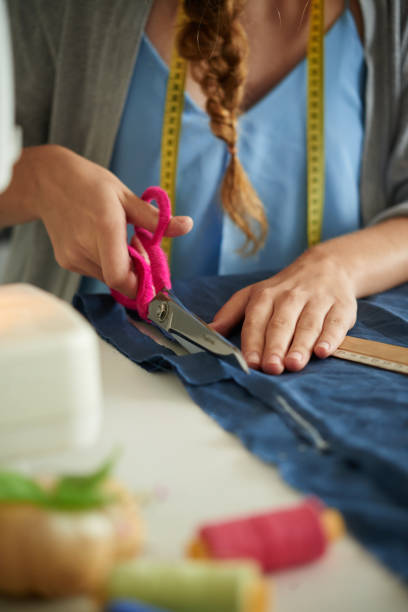 istock Cutting piece of fabric 910360422