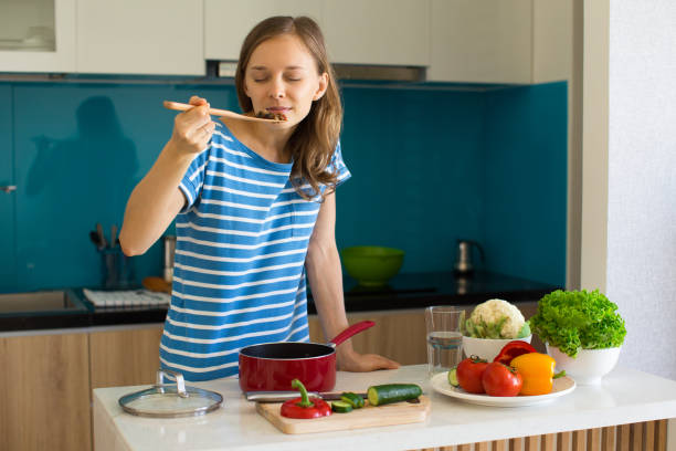 istock Content Woman Cooking and Smelling Food 910361966