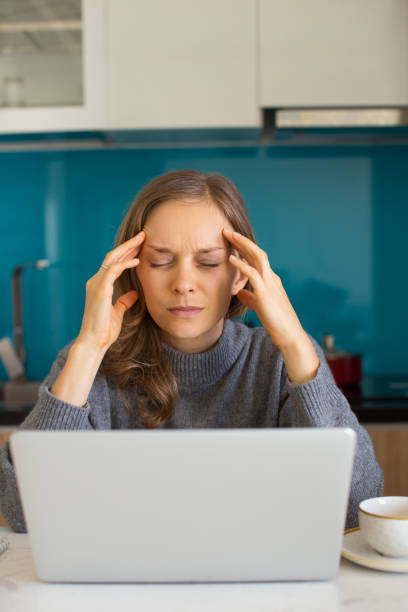 istock Young Woman Working on Laptop and Thinking Hard 910363036