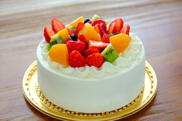 istock Cake with exotic fruits over wooden background 910364034