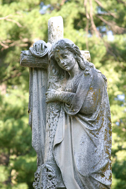 istock statue of girl and cross 91036413