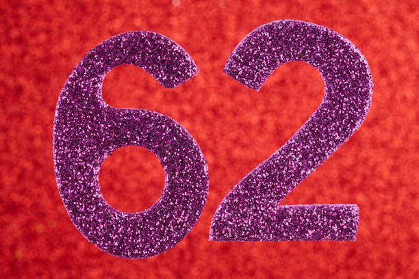 istock Number sixty-two purple color over a red background. Anniversary 910365624
