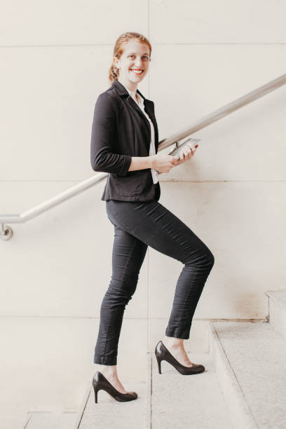 istock Happy Business Lady Climbing up Stairs With Tablet 910366690