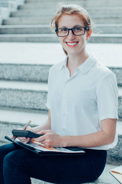 istock Smiling Business Woman Working on Stairs 910366714