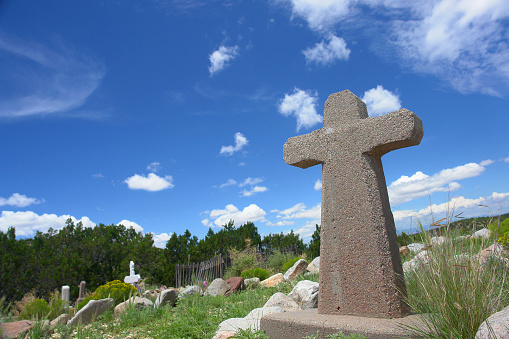 One cross on the hill with clouds moving on blue starry sky. Easter, resurrection, new life, redemption concept.