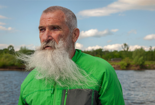 Portrait Senior Man with White Beard on a journey through the Russian rivers,Oka