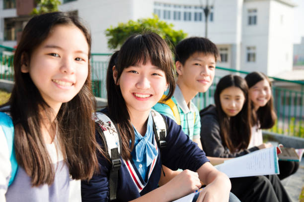 istock Group Of Teenage Students study in school 910377662