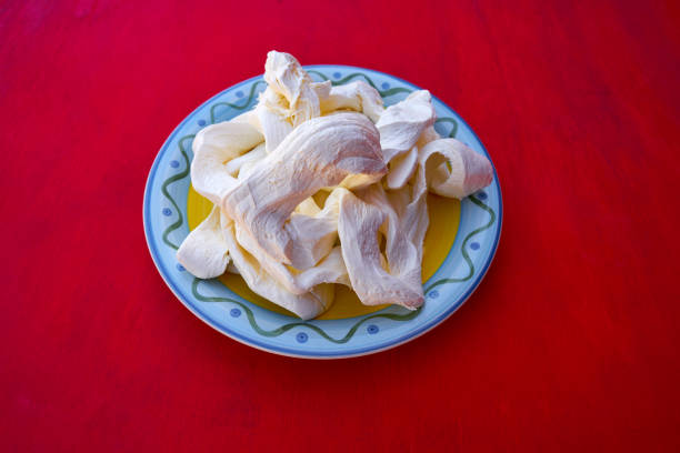 Oaxaca cheese from Mexico in a plate on red background