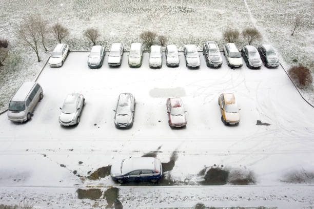 istock Ground parking cars after snowfall, view from above. 910384712