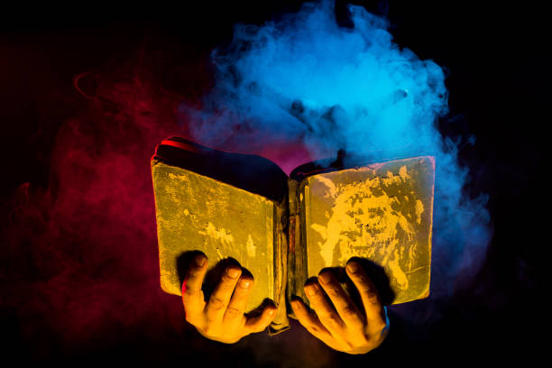 Hand holding the Bible up to the sky.related: