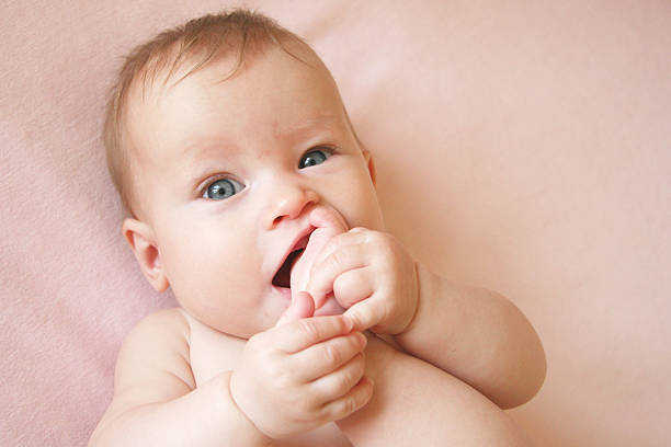 Baby Girl With Foot in her Mouth stock photo