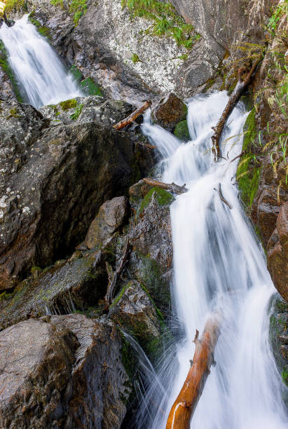 istock mountain waterfall flowing between the rocks in the summer 910403642