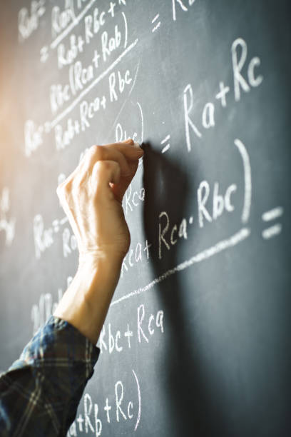 istock The teacher writes on a board with chalk a formula for electric current 910404276