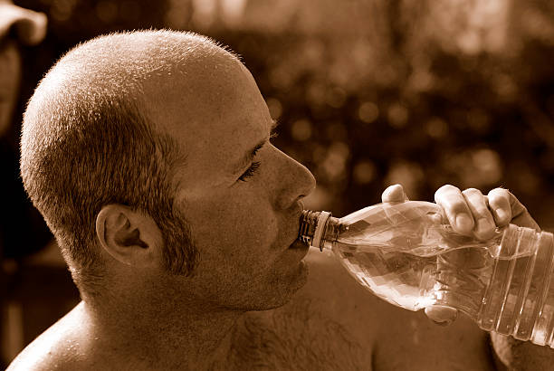 Male drinking water - Sepia Toned stock photo