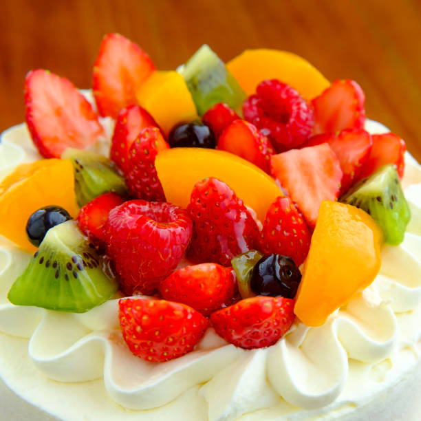 istock Cake with exotic fruits over wooden background 910411948