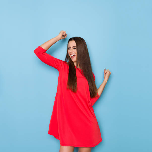 Young Woman Is Laughing With Arms Raised
