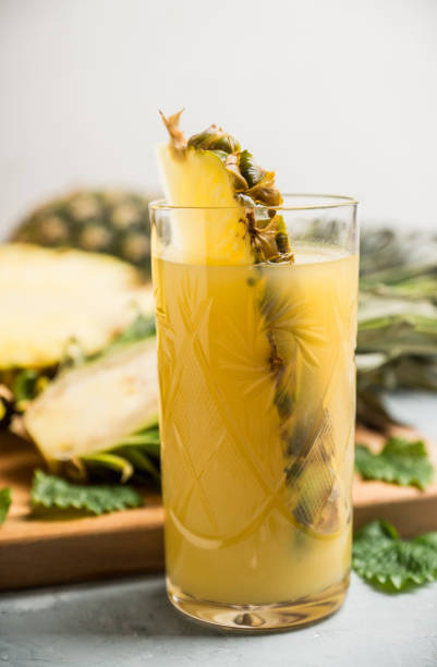 istock Glass of pineapple juice on the rustic background 910418748