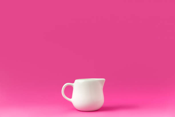 istock close-up view of single empty white jug ready for breakfast isolated on pink 910419496