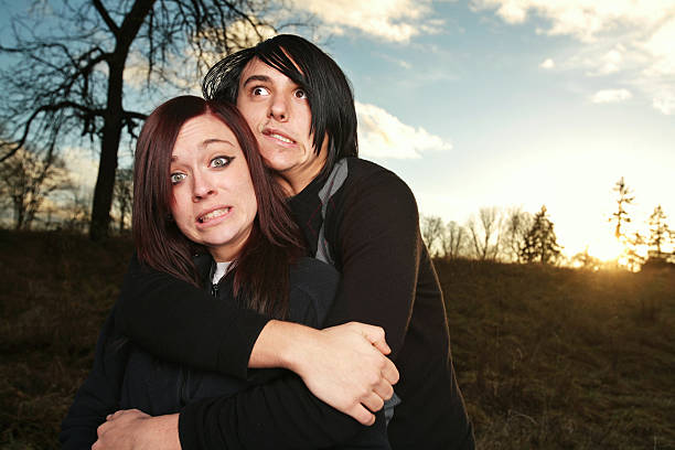 Sad young woman looking over her partner's shoulder.