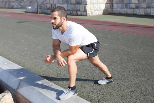 istock Focused Sportsman Stretching after Training 910421758