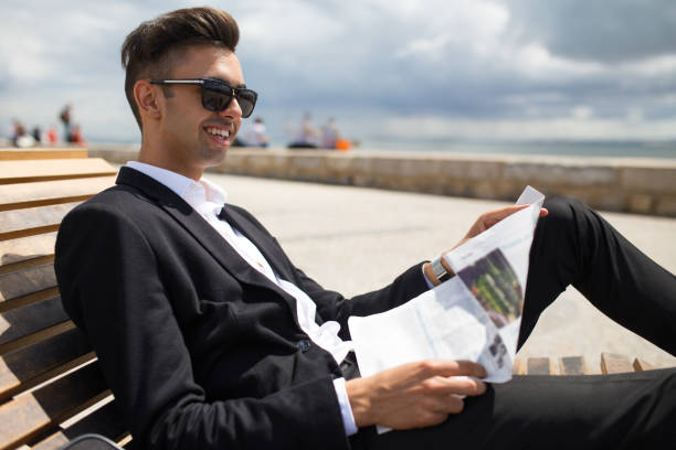 Positive relaxed man resting with newspaper