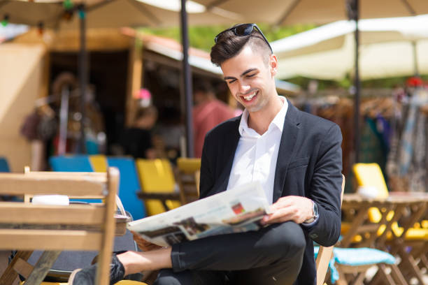 istock Cheerful young man enjoying morning news 910423664