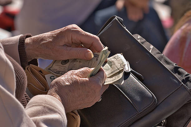 Elderly Woman counting money stock photo