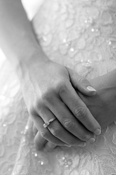Wedding dress and hands stock photo