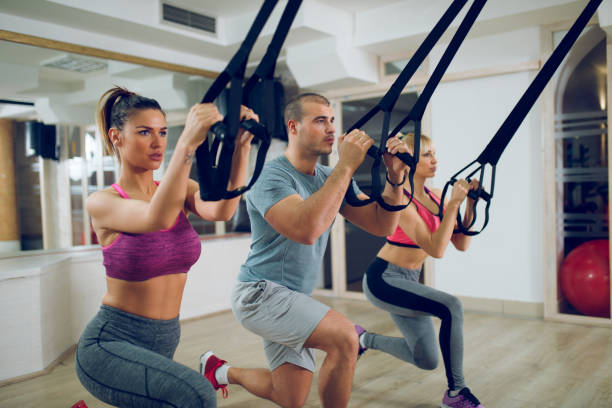 istock TRX suspension training- people doing arm and leg exercises. 910430902